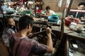 Goldsmith melts the gold with gun fire lighter welding to create precious accessory. Koh Kong Market. Koh Kong Province, Cambodia